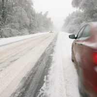 Red car driving in the snow Red car driving in the snow