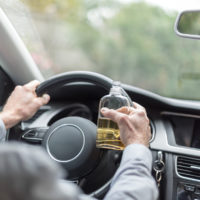 Man drinking alcohol and driving