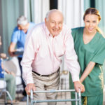 Nurse assisting a man in nursing home facility Nurse assisting a man in nursing home facility