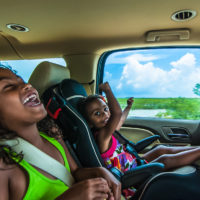 Brazilian girls singing and laughing sitting in backseat in car Brazilian girls singing and laughing sitting in backseat in car