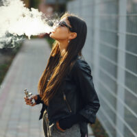 stylish girl smoking an e-cigarette stylish girl smoking an e-cigarette