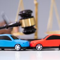 Two Cars On Desk In Courtroom