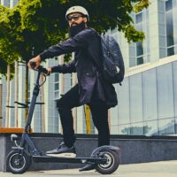 A man posing on electric scooter. A man posing on electric scooter.