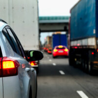 Image of big trucks in traffic, depicting potential for accidents and the need to contact WV tractor-trailer accident lawyers.