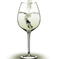 Image of car sinking into wine, depicting how dram shop liability attorneys like the ones at Burke, Schultz, Harman & Jenkinson help you get the compensation you deserve.