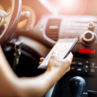Image of texting and driving, representing how a WV distracted driving accident lawyer can help hold the defendant responsible.