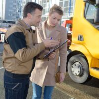 Recovery driver showing paperwork to customer Recovery driver showing paperwork to customer