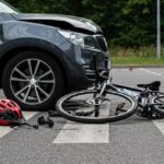 Bicycle accident scene with helmet on crosswalk near car Bicycle accident scene with helmet on crosswalk near car