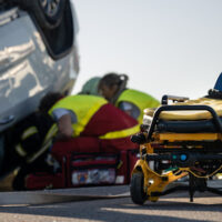 Emergency personnel work to help a car accident victim, representing how West Virginia car accident lawyers help clients recover.